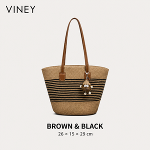 Brown and black striped woven straw tote with plush charm, front view and dimensions