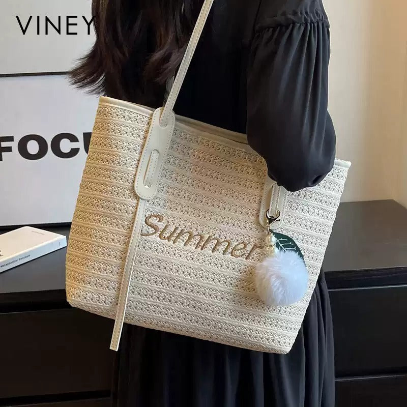 Woven straw tote styled with a summer outfit