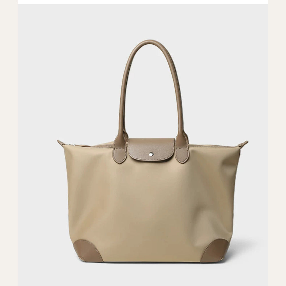 Light camel canvas travel tote with taupe flap, long handles and reinforced corners, front view