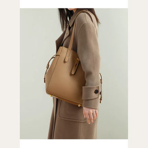 VINEY Winged Leather Bucket Tote Bag in brown, side carry