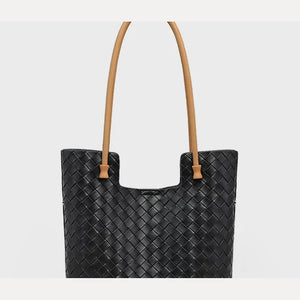 Upper front of black woven leather tote showing tan shoulder straps and woven texture